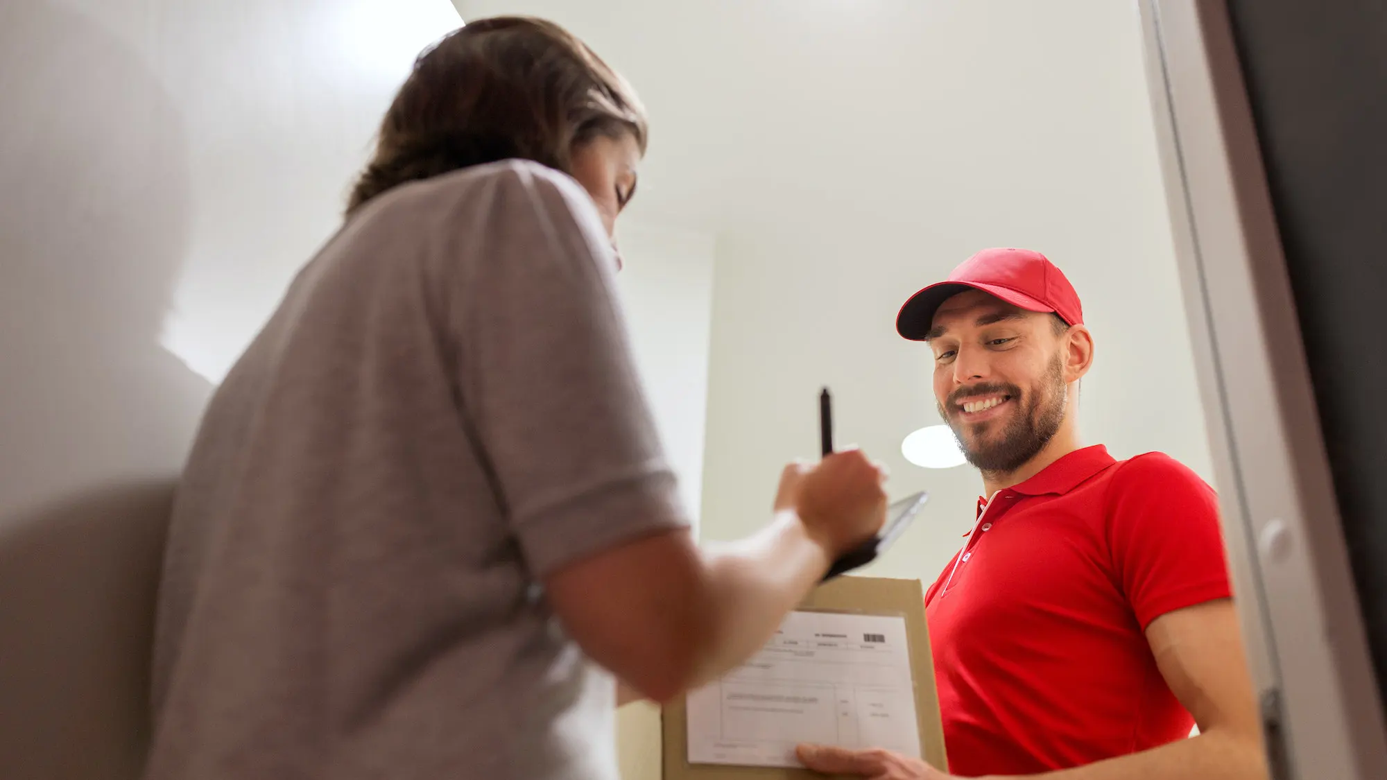 deliveryman-and-customer-with-parcel-boxes-at-home-1