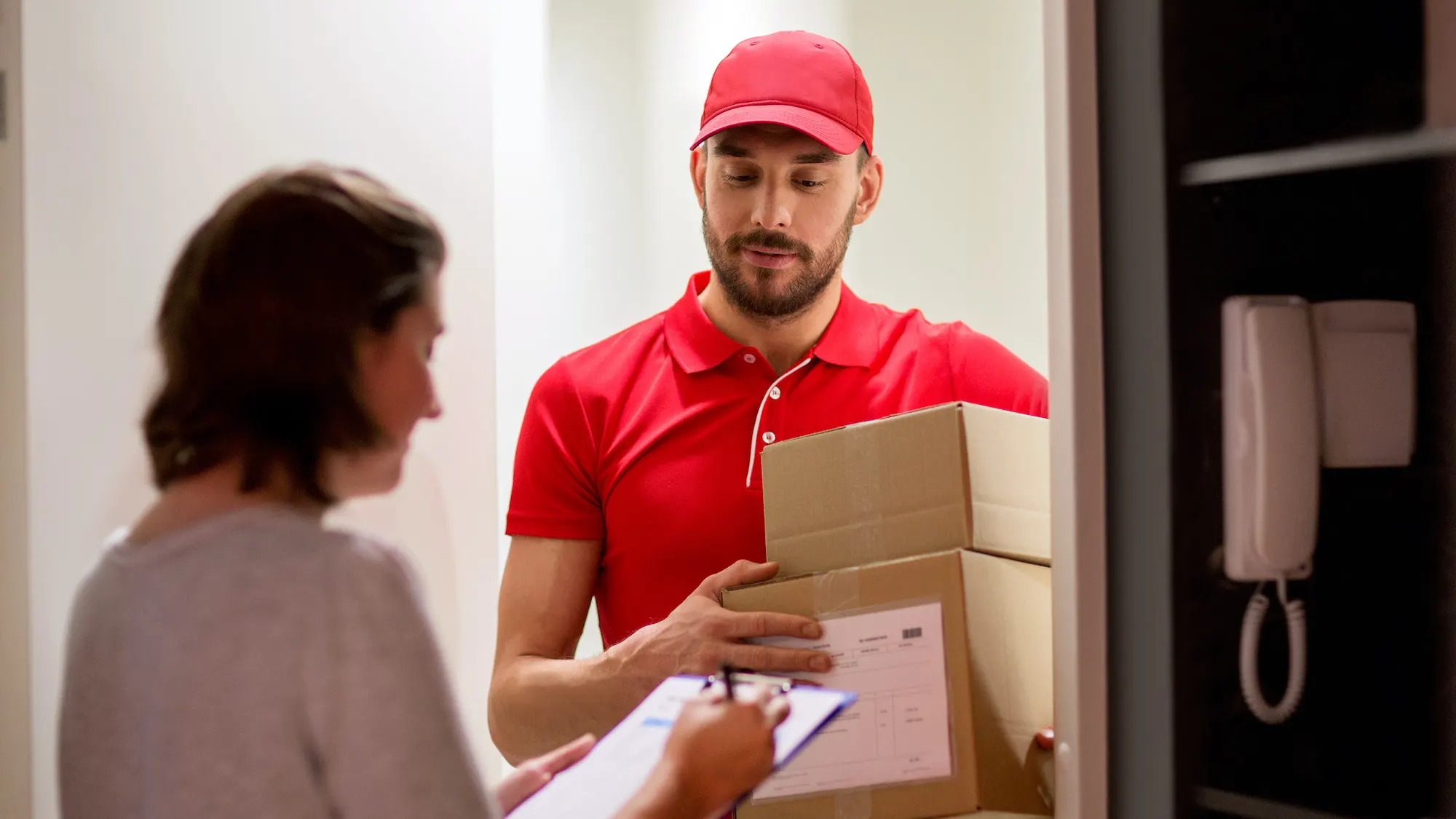 deliveryman-and-customer-with-parcel-boxes-at-home