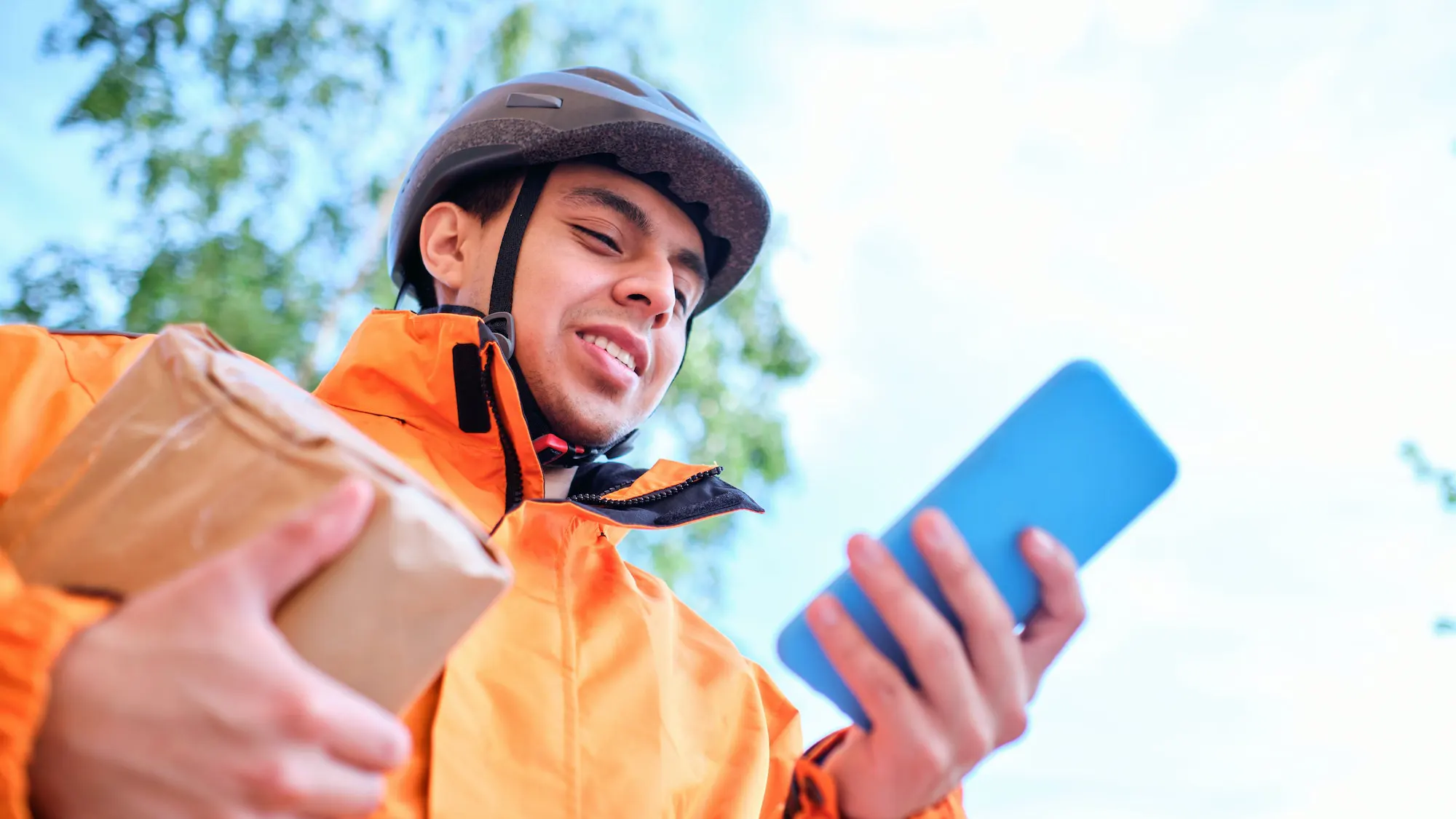 latino-delivery-man-uses-his-phone